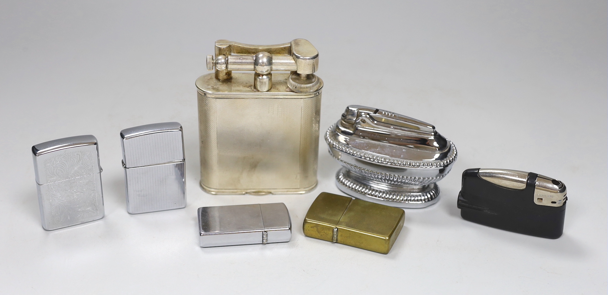 A Dunhill plated table lighter and six various other lighters, Dunhill table lighter 10cm high